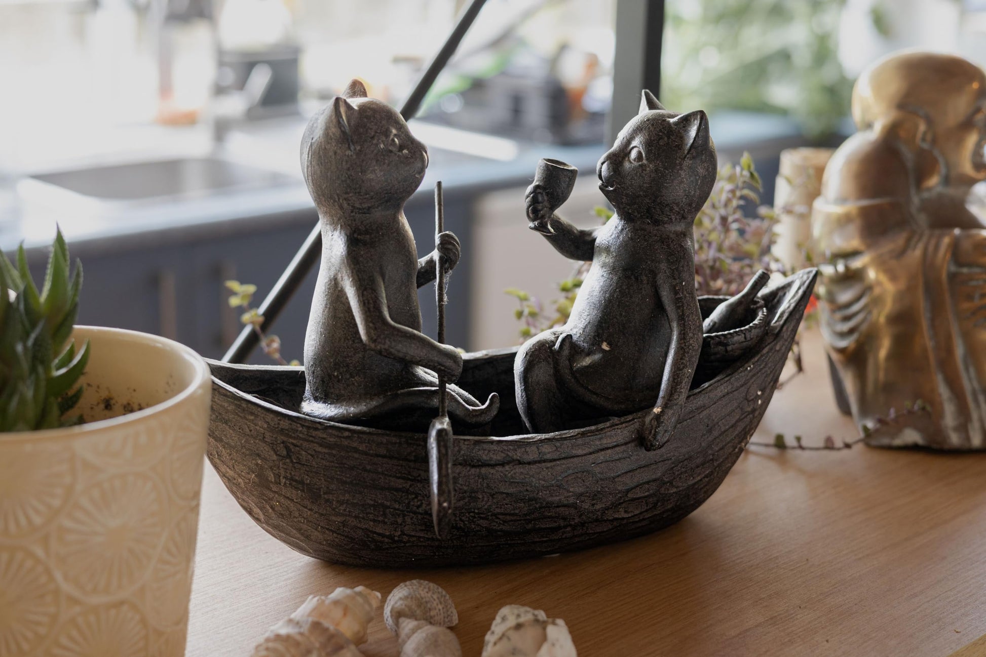 Side view of Cats Picnicking on a Boat figurine showing two cats rowing